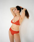 Model wearing the Esme bra in colour Chilli and Esme thong in colour Chili